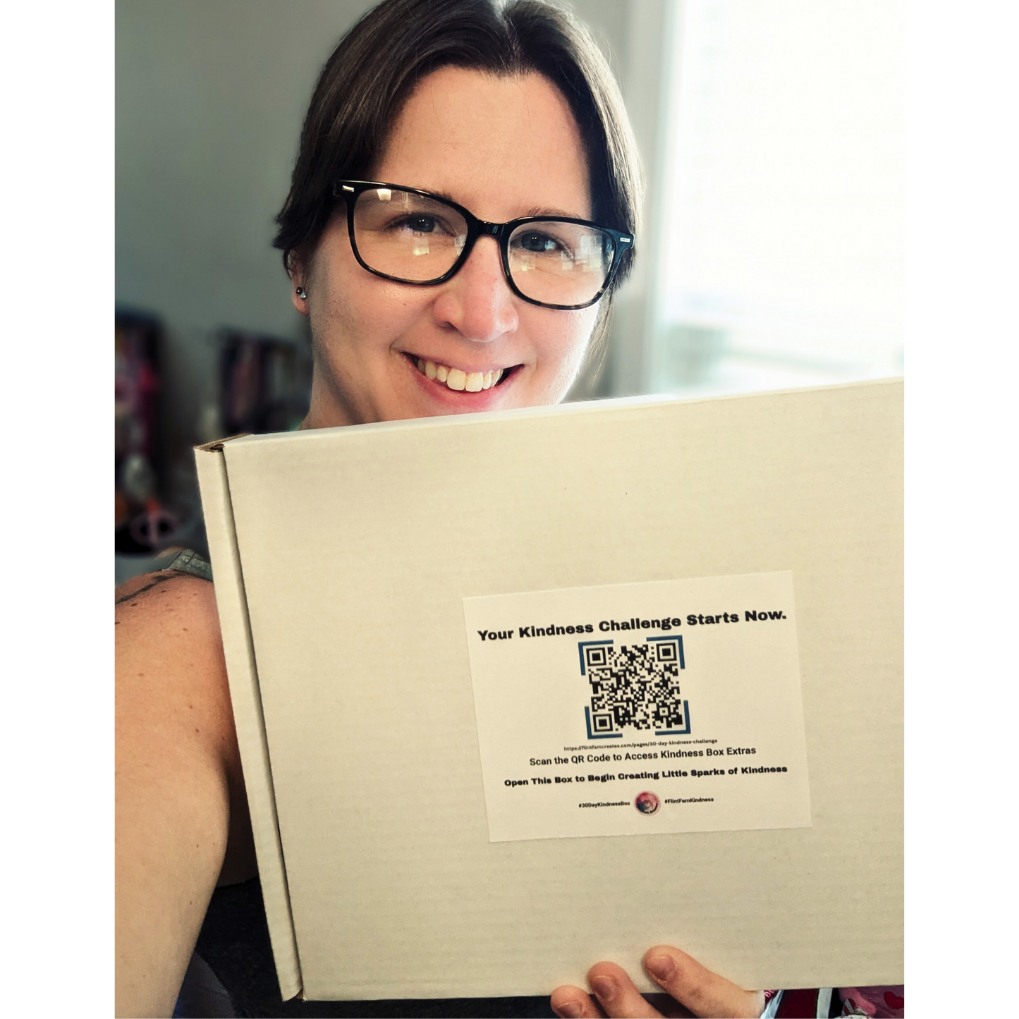 Meghan Flint is holding a completed 30-Day Kindness Challenge box by Flint Fam Creates.